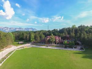 an aerial view of a house with a large green field at Natyral Razma Resort in Razëm