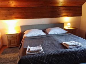 a bedroom with a large bed with towels on it at Apartment Ivana B in Lesce