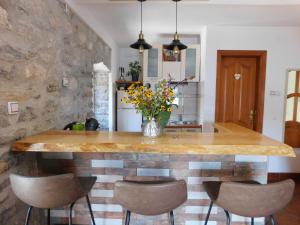 a kitchen with a large wooden table with chairs at Apartments Villa Serventi in Tivat