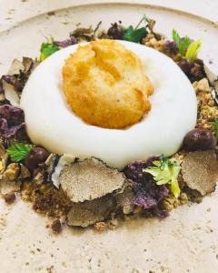a plate of food with a deviled egg on it at Casatorre dei Leoni Dimora Storica in Siena