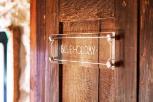 a sign on a wooden door that reads blue prophecy at LA BELLÊME BLEUE in Bellême