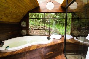 a bath tub in a bathroom with a window at Viva Brotas in Brotas