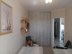 a bedroom with a bed and a cabinet and a table at Apartament w Głogowie in Głogów
