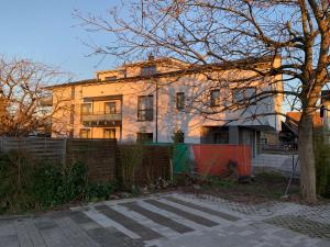 a building with a fence in front of it at Ferienwohnung Baselblick, Eimeldingen in Eimeldingen