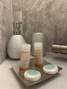 two bottles of moisturizers on a tray on a counter at Akrogiali Hotel in Agios Sostis