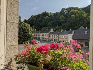 a view of a town from a window with flowers at Chailland Home with a view in Chailland