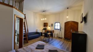 a living room with a blue couch and a table at Apartmány Turold Mikulov in Mikulov