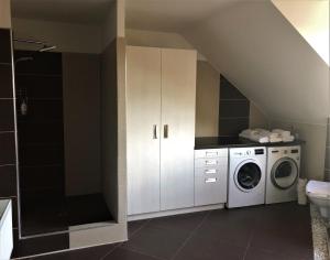 a laundry room with a washer and dryer at Villa Daniela in Úvaly