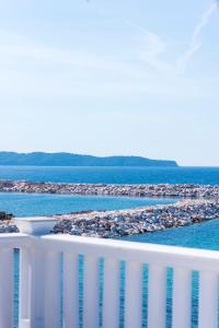 a view of the ocean from the balcony of a building at Hotel Samaras Beach in Limenaria