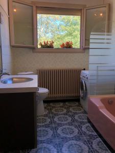 a bathroom with a sink and a washing machine at Jaures Home in Carmaux