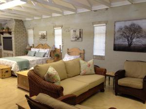 a living room with a couch and a bed at Anne's Place in Potchefstroom