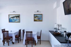 a dining room with a white table and chairs at Lumi Hotel in Sarandë