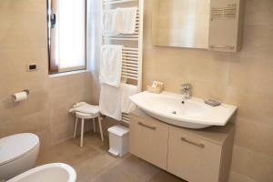 a bathroom with a white sink and a toilet at Albergo Milano in Boario Terme