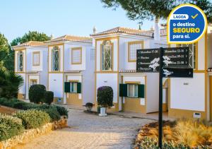 a building with a sign in front of it at Vale d'El Rei Hotel & Villas in Carvoeiro