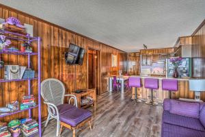 ein Wohnzimmer mit Holzwänden und lila Stühlen in der Unterkunft Oceanfront Myrtle Beach Condo about 9 Mi to Boardwalk! in Myrtle Beach