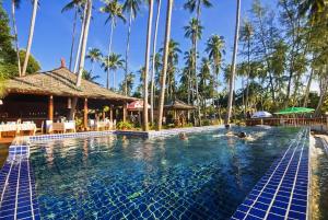 a swimming pool at a resort with palm trees at Lipa Bay Resort in Lipa Noi