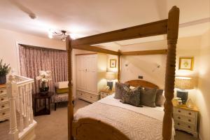 a bedroom with a bed with a wooden bed frame at Warkworth House Hotel in Warkworth +37 photos