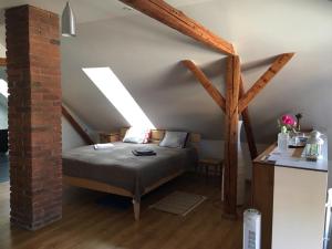 a bedroom with a bed in a attic at Podkroví s koupelnou in Svinařov