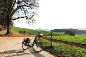 a bike parked on a road next to a fence at Modtrip Switzerland in Grünenmatt