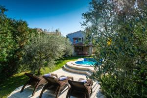 a group of chairs and a pool in a yard at Haus Albino in Kršan