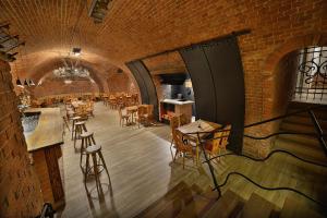 a room with tables and chairs and a brick wall at PREMIUM Wellness & Wine Hotel Znojmo in Znojmo