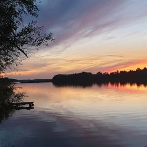 a view of a lake at sunset at GARDENIA RAJGRÓD in Rajgród