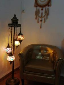 a living room with a couch and a chandelier at H Juan in Marbella