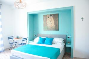 a bedroom with blue walls and a bed with blue pillows at Casa del Corso in Sorrento