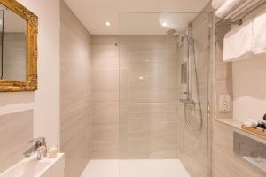 a bathroom with a shower with a glass door at Warkworth House Hotel in Warkworth