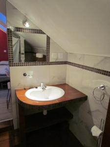 a bathroom with a sink and a mirror at Pokoje gościnne OSKAR in Łeba