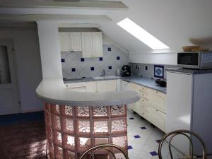a kitchen with white cabinets and a counter top at Apartment Ivana B in Lesce +23 photos