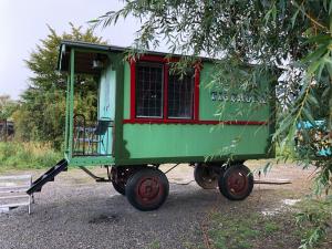 a small green wagon with a horse attached to it at Grand Circus Hotel in Malmö
