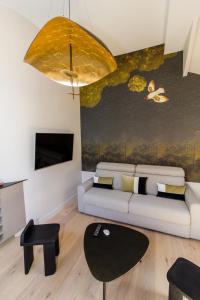 a living room with a couch and a table at La Noctambulle Forum in Reims