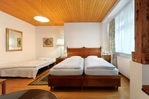 Postel nebo postele na pokoji v ubytování Hotel National Bern