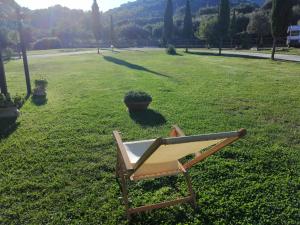 a chair sitting on the grass in a field at Casale Valle Agnese in Godrano