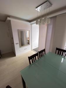 a dining room with a table and chairs and a mirror at Golden Apartment in La Garita