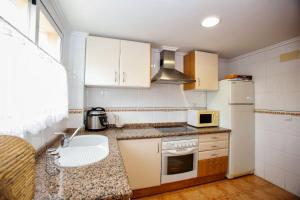 a small kitchen with a sink and a microwave at Poseidon Denia in Denia