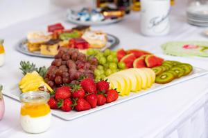 a plate of fruit and vegetables on a table at Landhotel Behre in Lehrte