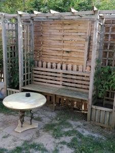 a wooden bench with a table in front of it at Le sacré cœur bis -duplex 5pl in Le Havre