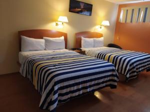 Postel nebo postele na pokoji v ubytování Hotel Florencia Regency