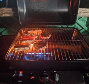 a grill with some food cooking in an oven at The Dream in Massa Lubrense