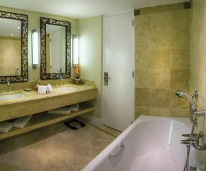 a bathroom with a tub and two sinks and a shower at Sanctuary Lodge, A Belmond Hotel, Machu Picchu in Machu Picchu