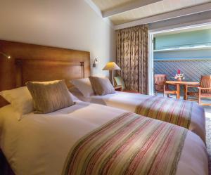 
A bed or beds in a room at Sanctuary Lodge, A Belmond Hotel, Machu Picchu

