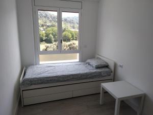 A bed or beds in a room at Apartamento boltaña