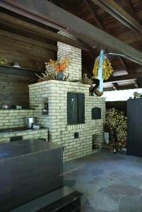 a kitchen with a stone fireplace in a house at Dom Andrzeja in Surażkowo