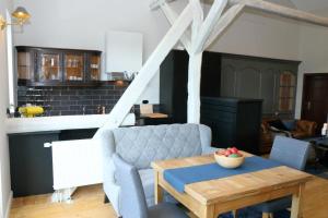 a living room with a couch and a table at Apartment in Buchholz