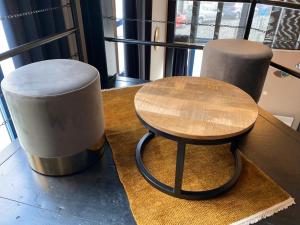 a table and two stools sitting on a table at Luxury Suites in Antwerp
