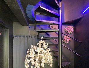 a staircase with a christmas tree in a room at Luxury Suites in Antwerp
