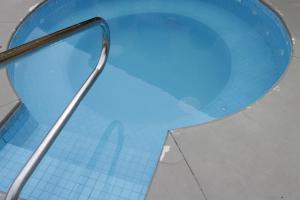 a blue toilet seat with a metal handle on it at Holiday Inn Express Chihuahua, an IHG Hotel in Chihuahua