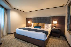 Postel nebo postele na pokoji v ubytování Grand Hotel Tijuana